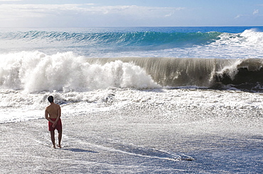 Man standing in front of a giant wave, La Palma, Canary Islands, Spain, Europe