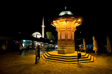 Pedestrian area with a fountain at night, Sarajevo, Bosnia, Europe