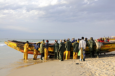 Fishermen pushing their boats back onto the beach, Nouakchott, Western Africa, Mauritania, Africa