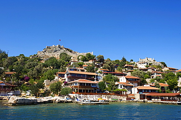 Castle and scenic restaurants in Kale Simena, Lycia, southern coast of Turkey, Western Asia