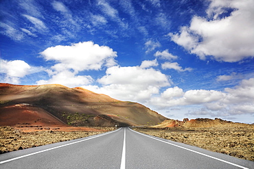 Road through the volcanic landscape in the Timanfaya National Park, Lanzarote, Canary Islands, Spain, Europe