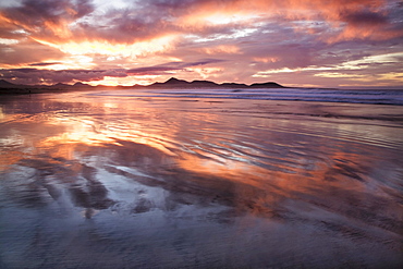 Sunset reflecting over Famara Beach, Lanzarote, Canary Islands, Spain, Europe