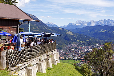 St. Martin am Grasberg mountain inn, also known as Martinshuette, view of Garmisch-Partenkirchen, Werdenfelser Land region, Upper Bavaria, Bavaria, Germany, Europe