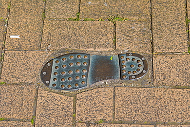 Thomas Tredyngton's footprint in the pavement by Catchcold Tower, medieval city walls, city centre, Southampton, Hampshire, England, United Kingdom, Europe