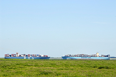 Two container vessels passing one another on the lower Elbe River, Schleswig-Holstein, Germany, Europe