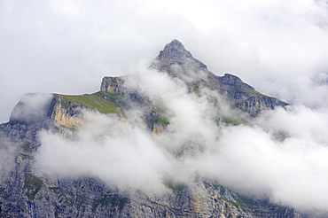 The 2649 metre high Schwarzmoench Mountain in the Bernese Alps, rising above the clouds, Canton of Bern, Switzerland, Europe