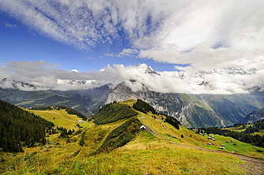 View down to Allmendhubel Mountain, below Schilthorn Mountain, towards the cloud-covered Bernese Alps, Canton of Bern, Switzerland, Europe