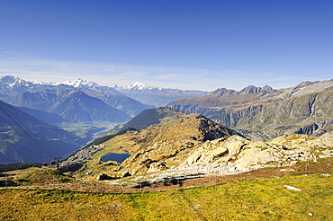 View from Bettmerhorn Mountain, 2872 metres high, down to Bettmeralp with Bettmersee lake and the Rhone Valley with the Pennine Alps on the horizon, Canton of Valais, Switzerland, Europe