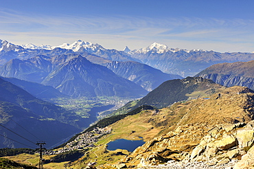 View from Bettmerhorn Mountain, 2872 metres high, down to Bettmeralp with Bettmersee lake and the Rhone Valley with the Pennine Alps on the horizon, Canton of Valais, Switzerland, Europe