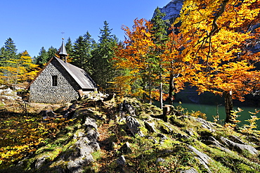 Chapel on Seealp Lake with autumnal vegetation, Canton of Appenzell Inner-Rhodes, Switzerland, Europe