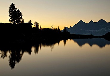 Mountains and trees reflected in Lake Spiegelsee in the last evening light, Reiteralm, Spiegelsee, Styria, Austria, Europe