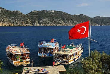 Turkish flag and boats on the quayside, village of Kale, Kalekoey or Simena, Kekova Bay, Lycian coast, Antalya Province, Mediterranean, Turkey, Eurasia