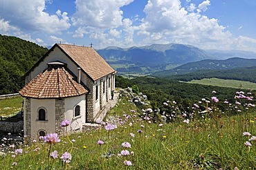 Hikers at the church Santa Maria di Monte Tranquillo, Villetta Barrea, National Park of Abruzzo, Italy, Europe