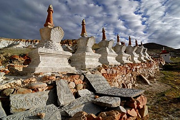 Tibetan Mani Stones in front of Chorten or Stupas at the holy pilgrimage site of Thirtapuri, Mount Kailash, Ngari Province, western Tibet, Tibet, China, Asia