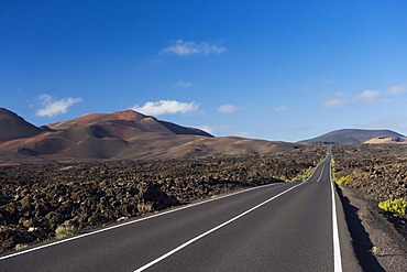 Road through the volcanic landscape in Montana del Fuego de Timanfaya National Park, Lanzarote, Canary Islands, Spain, Europe