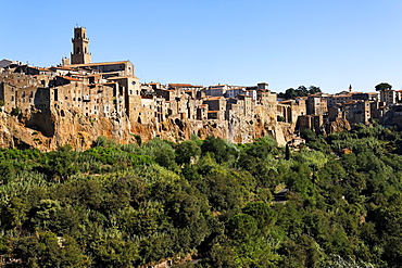 View to medieval limestone town of Pitigliano, situated on rocks raising from a green valley, Maremma, Tuscany, Italy, Europe