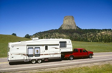 Pick up with trailer in front of Devils Tower, Wyoming, USA