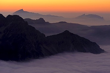 Mountain valley under fog with mountain peaks in the evening light, Allgaeu Alps, Kleinwalsertal valley, Vorarlberg, Austria, Europe