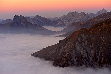 Mountain valley under fog with mountain peaks in the evening light, Allgaeu Alps, Kleinwalsertal valley, Vorarlberg, Austria, Europe