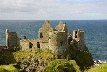 Ancient ruins Dunluce Castle on a cliff on the coast, County Antrim, Northern Ireland, United Kingdom, Europe