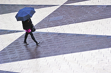 Woman with umbrella at Sergels Torg in the center of Stockholm, Sweden, Europe