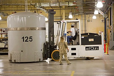 Workers prepare transuranic nuclear waste from America's nuclear weapons program for long-term storage at the Waste Isolation Pilot Plant, here a fork lift moves a TRUPACT shipping container used to transport nuclear waste by truck from distant places.; t