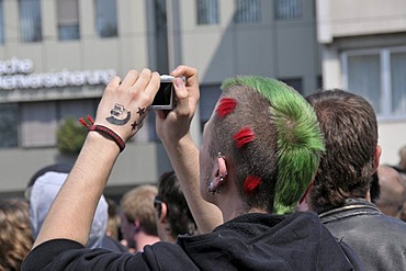 Punk taking a photograph at a NPD rally in Ulm, Baden-Wuerttemberg, Germany, Europe