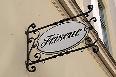 Hairdresser sign hanging above entrance