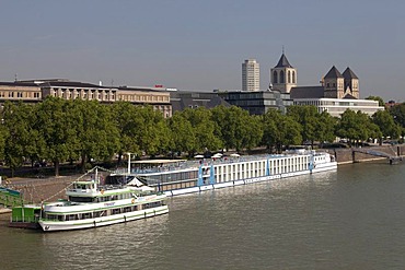 Passenger ships on the bank of the Rhine river, St. Kunibert church, Cologne, North Rhine-Westphalia, Germany, Europe