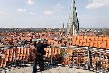 Couple looking from the terrace of the water tower on the historic old town, Lueneburg, Lower Saxony, Germany, Europe