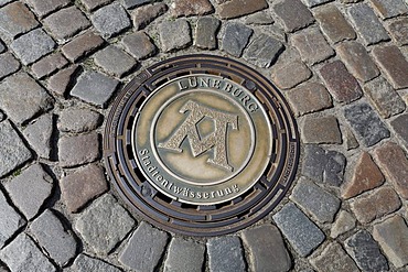 Manhole cover of the municipal water treatment works, old pavement, Lower Saxony, Germany, Europe