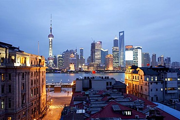 Illuminated Shanghai skyline at dusk, Pudong financial district, Jin Mao Tower, SWFC and Oriental Pearl Tower, Huangpu River, Puxi, Shanghai, China, Asia