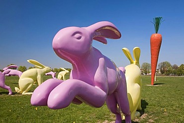 Bunny sculptures arranged around a carrot sculpture, Scharnhauser Park district, Ostfildern, Baden-Wuerttemberg, Germany, Europe