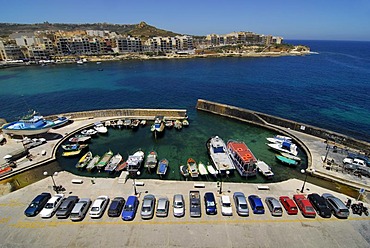 Parked cars and fishing boats in the harbour area, Marsalforn Bay, Marsalforn, Island of Gozo, Malta, Mediterranean Sea, Europe