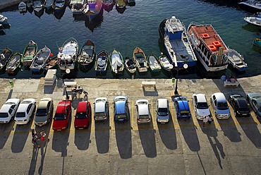 Parked cars and fishing boats in the harbour, Bay of Marsalforn, Marsalforn, Gozo Island, Malta, Mediterranean Sea, Europe