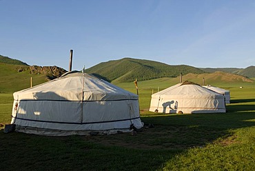 Yurt camp or ger camp in the grasslands at the Orkhon Waterfall in front of the mountains of the Khuisiin Naiman Nuur Nature Reserve, Orkhon Khuerkhree, Kharkhorin, Oevoerkhangai Aimak, Mongolia, Asia