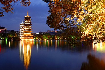 Shanhu Lake with brightly lit pagodas, Sun and Moon Pagodas, Chinese city of Guilin, Guangxi, China, Asia