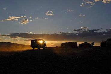 Russia last four-wheel van reaching a yurt camp or ger camp in the last sunlight, in front of the great Khorgoryn Els sand dunes in the Gobi Desert, Gurvan Saikhan National Park, Oemnoegov Aimak, Mongolia, Asia