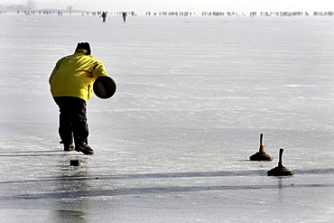 Bavarian game of Eisstock, ice stock, on frozen lake Chiemsee, Chiemgau, Upper Bavaria, Germany, Europe