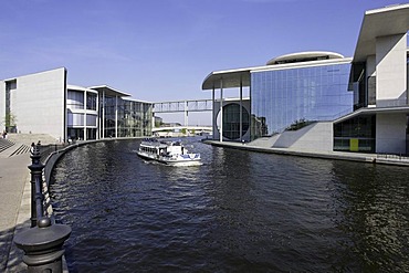 Tourist boat on the Spree River passing the Marie-Elisabeth-Lueders-Haus building, Berlin, Germany, Europe