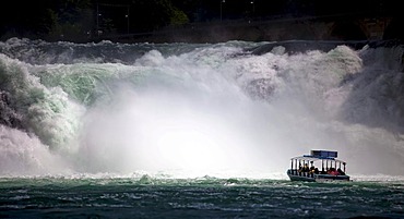 Small pleasure boat in front of the waterfalls near Schaffhausen, Rhine Falls, Schaffhausen, Switzerland, Europe