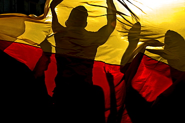 German football fans celebrating a victory behind a German flag