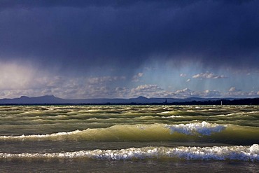 Storm Xynthia causing high waves on the shore of Reichenau island and rain, looking towards Radolfzell, Lake Constance, Untersee lake, Landkreis Konstanz county, Baden-Wuerttemberg, Germany, Europe