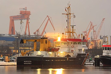 Harbor view with the ship of the maritime police, crane of the North Sea Works in the back, Emden, East Frisia, Lower Saxony, Germany, Europe