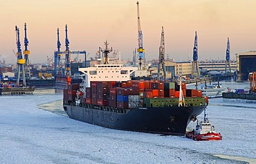 Container ship on the Elbe river in the wintery port of Hamburg, Germany, Europe