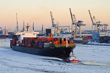 Container ship on the Elbe river in the wintery port of Hamburg, Germany, Europe