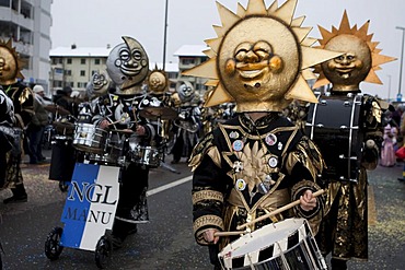 Guggenmusik Noelli Groetze group dressed to the theme of Sole Luna, Sun and Moon, during the carnival procession in Littau, Lucerne, Switzerland, Europe