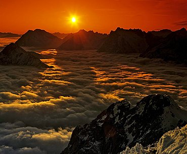 Panoramic shot of the Wetterstein Range taken from the Karwendel Range, sea of fog in evening light, Upper Bavaria, Bavaria, Germany, Europe