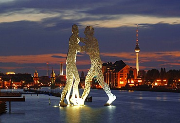 Molecule Men, sculpture by American artist Jonathan Borofsky, standing in the Spree river, overlooking the Oberbaumbruecke bridge, Osthafen harbor, Friedrichshain and tv tower, Treptow district, Berlin, Germany, Europe