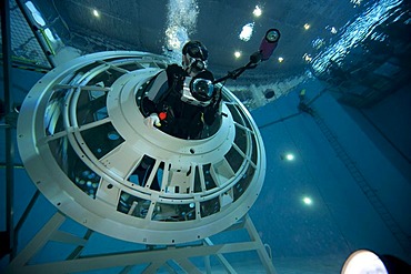 Backup divers and astronauts practicing with a space station module reproduction in a diving basin, underwater photographers are documenting the training session, European Space Agency, ESA, European Astronaut Center, EAC, Cologne, North Rhine-Westphalia,